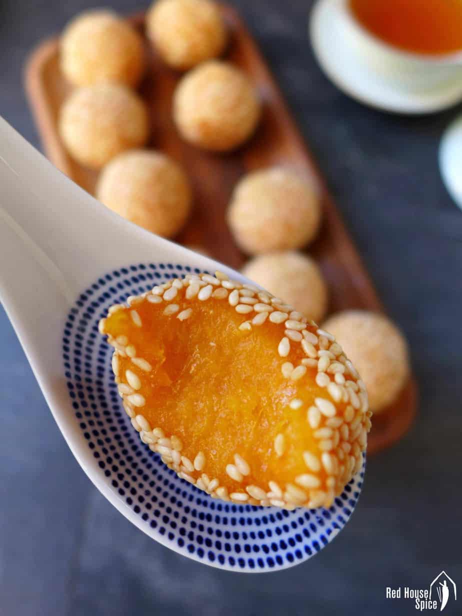 A half-eaten sweet potato sesame ball