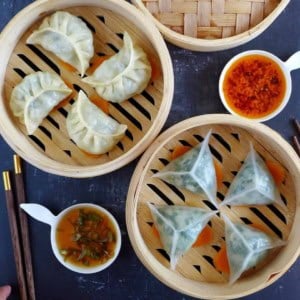 two types of steamed dumplings in bamboo baskets