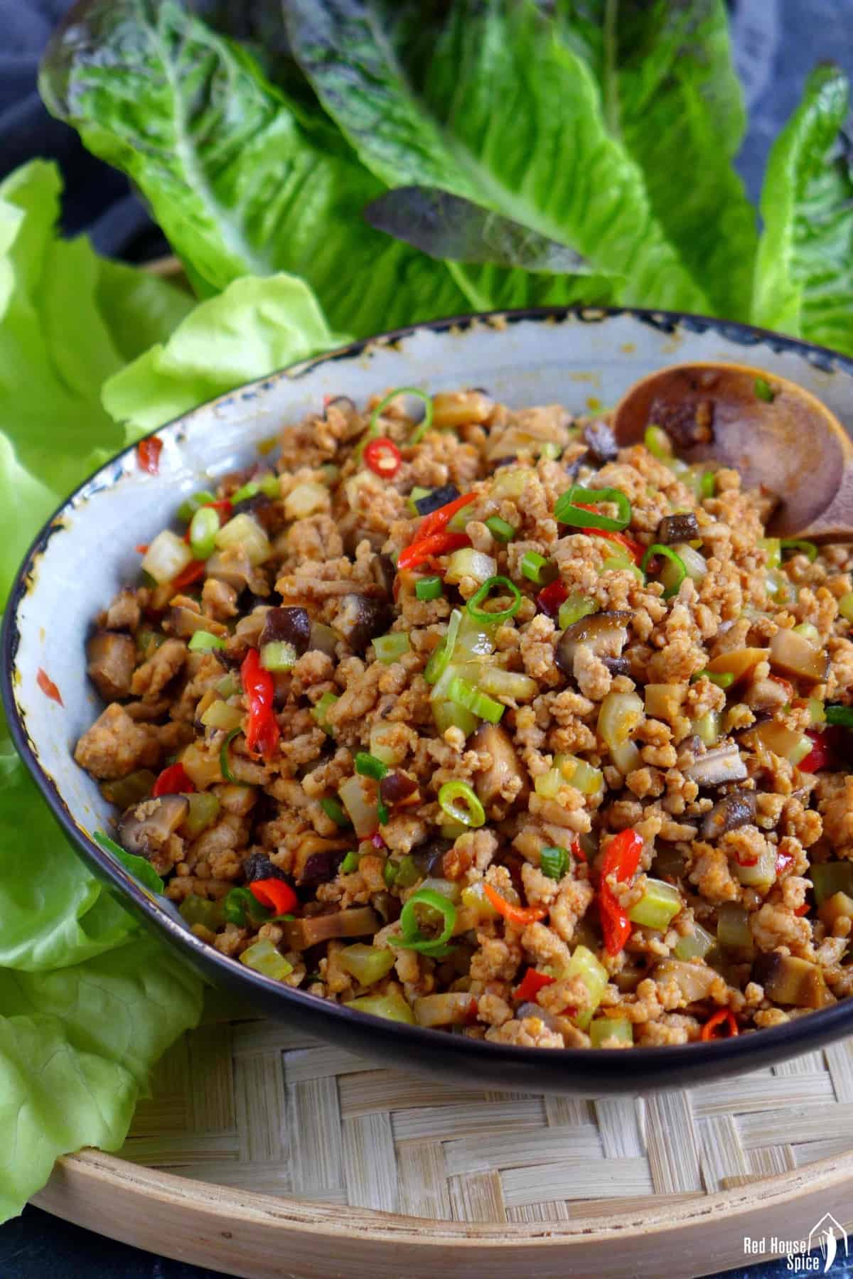 a bowl of stir-fried minced pork with mushroom, celery and spicy seasonings.