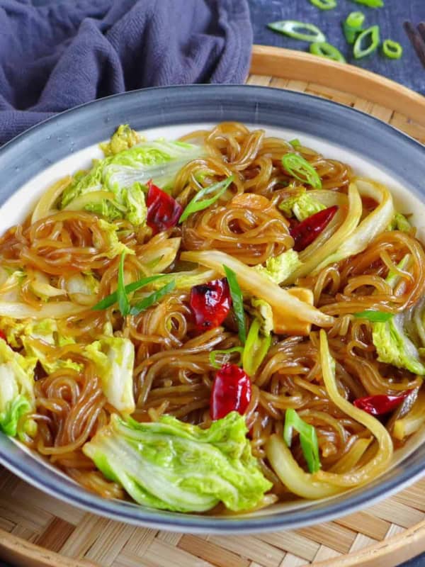 a plate of glass noodles braised with Napa cabbage