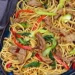 fried noodles with beef and vegetables with overlay text that says beef chow mein.