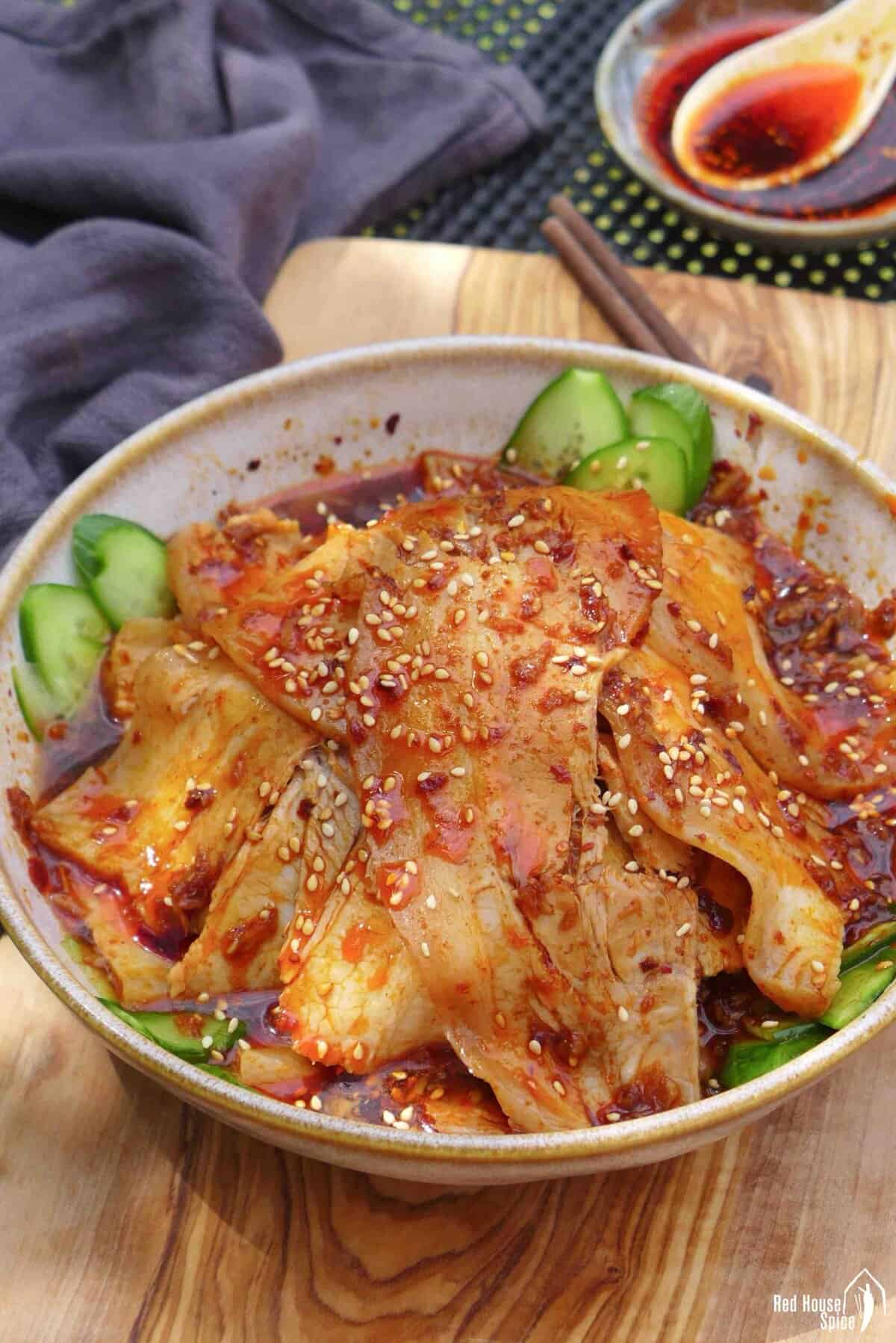 slices of pork over cucumber in a spicy dressing.